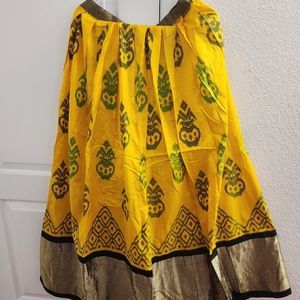 Beautiful yellow ikkat pattu lehenga with black blouse, green dupatta